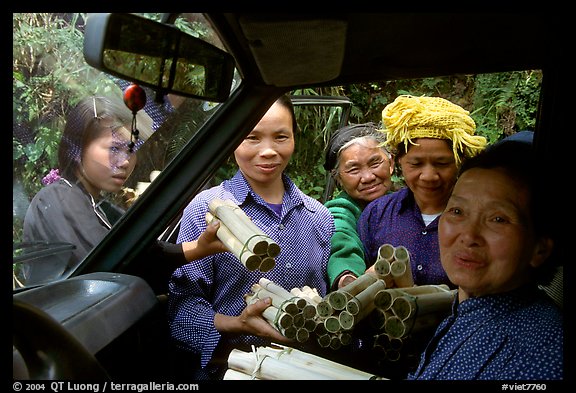 Peddlers offering sweet rice tubes for sale to traveler. Vietnam