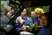 Peddlers offering sweet rice tubes for sale to traveler. Vietnam