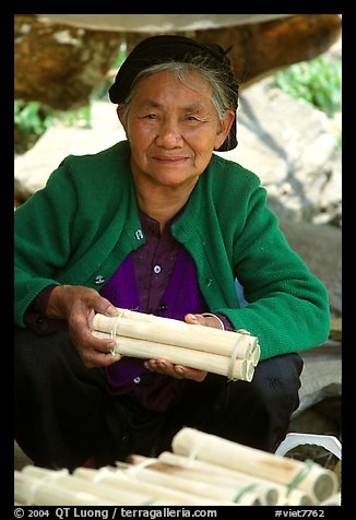 Woman selling sweet rice cooked in bamboo tubes. Vietnam