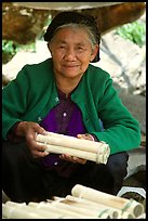 Woman selling sweet rice cooked in bamboo tubes. Vietnam