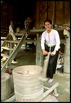 Woman of the Thai ethnicity milling grain, near Mai Chau. Northwest Vietnam