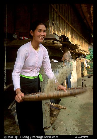 Woman of the Thai ethnicity sorting grain, near Mai Chau. Vietnam