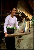 Woman of the Thai ethnicity sorting grain, near Mai Chau. Vietnam