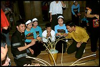 Thai women and guests drinking rau can alcohol with long straws, Ban Lac, Mai Chau. Northwest Vietnam ( color)