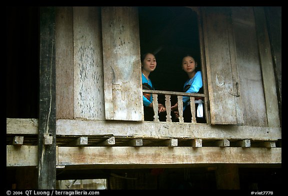 Two thai women at the window of their stilt house, Ban Lac village. Northwest Vietnam