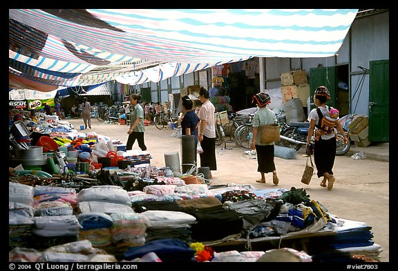 Thai women walk in a town market, near Son La. Northwest Vietnam (color)