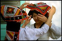A thai woman helps her friend with her elaborate headdress, Son La. Northwest Vietnam ( color)