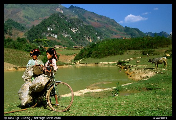 Thai women load a bicycle, near Tuan Giao. Northwest Vietnam (color)