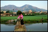 Thai woman pushing her bicycle across a bridge, Tuan Giao. Northwest Vietnam ( color)