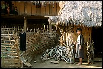 Woman in front of her hut and family on stilt house, between Lai Chau and Tam Duong. Northwest Vietnam (color)
