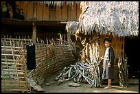 Woman in front of her hut and family on stilt house, between Lai Chau and Tam Duong. Northwest Vietnam ( color)