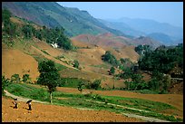 Two montagnards walking down a field, between Tuan Giao and Lai Chau. Northwest Vietnam (color)