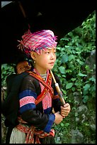 Hmong girl sheltering herself and her younger sibling with an unbrella, between Lai Chau and Tam Duong. Northwest Vietnam