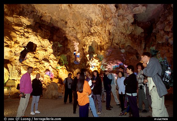 Tourists in illuminated cave. Halong Bay, Vietnam