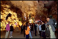 Tourists in illuminated cave. Halong Bay, Vietnam