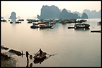 Rowboat meeting woman on shore. Halong Bay, Vietnam ( color)