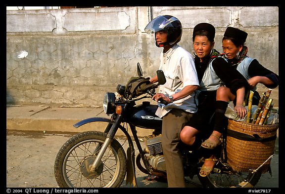 Black Hmong Women riding at the back of a Russian motorbike. Sapa, Vietnam (color)