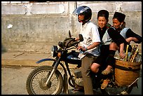 Black Hmong Women riding at the back of a Russian motorbike. Sapa, Vietnam