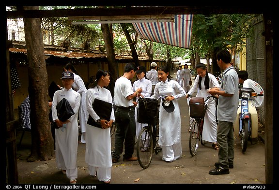 Uniformed school girls exit school. Ho Chi Minh City, Vietnam