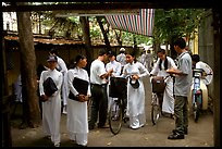 Uniformed school girls exit school. Ho Chi Minh City, Vietnam ( color)