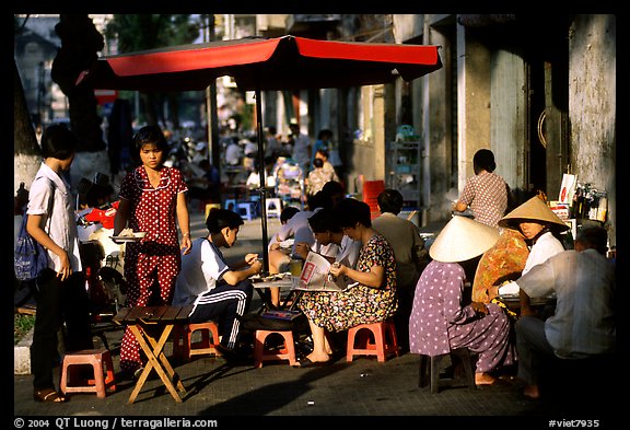 Eating in a street restaurant. Ho Chi Minh City, Vietnam (color)