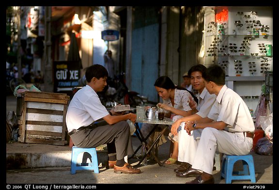 Enjoying a cafe on the streets, sitting on the typical tiny chairs. Ho Chi Minh City, Vietnam (color)
