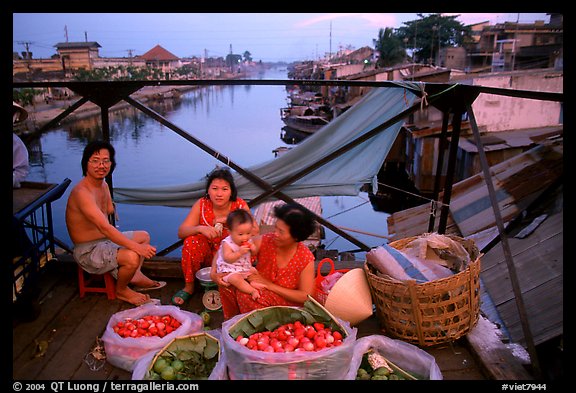 Family selling fruit on a bridge. Cholon, Ho Chi Minh City, Vietnam