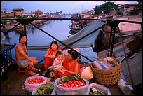 Family selling fruit on a bridge. Cholon, Ho Chi Minh City, Vietnam