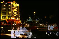 Night traffic in front of a sign celebrating the 300 years of Saigon. Ho Chi Minh City, Vietnam (color)