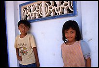 Two kids in front of a wall. Ben Tre, Vietnam (color)