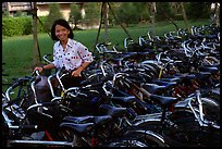 Woman retrieving her bicycle from a bicyle parking area. Mekong Delta, Vietnam