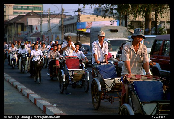 Cyclos and morning traffic. Ho Chi Minh City, Vietnam (color)