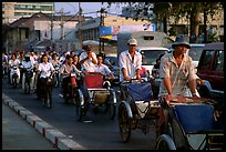 Cyclos and morning traffic. Ho Chi Minh City, Vietnam ( color)