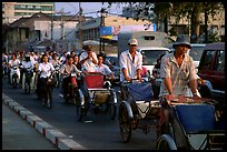 Cyclos and morning traffic. Ho Chi Minh City, Vietnam (color)