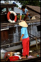 Passsing a bowl of pho from boat to boat. Can Tho, Vietnam