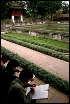 Art students drawing in the Temple of the Litterature. Hanoi, Vietnam (color)