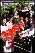 Gifts are exchanged as a newly wedded couple exits the bride's home. Ho Chi Minh City, Vietnam