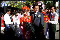 Newly-wed couple exit the bride's home. Ho Chi Minh City, Vietnam