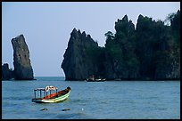 Small boats and offshore rock formations. Hong Chong Peninsula, Vietnam (color)