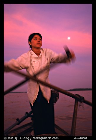 Woman using X-shaped paddles on the Mekong river, Can Tho. Vietnam