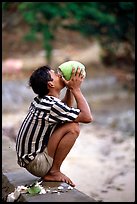 Drinking fresh coconut juice, cheaper than bottled water. Hong Chong Peninsula, Vietnam