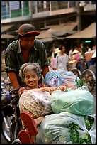 Elderly woman back from the market with plenty of groceries makes good use of cyclo. Cholon, Ho Chi Minh City, Vietnam