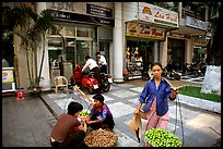 Old and new: street fruit vendors and computer store. Ho Chi Minh City, Vietnam (color)