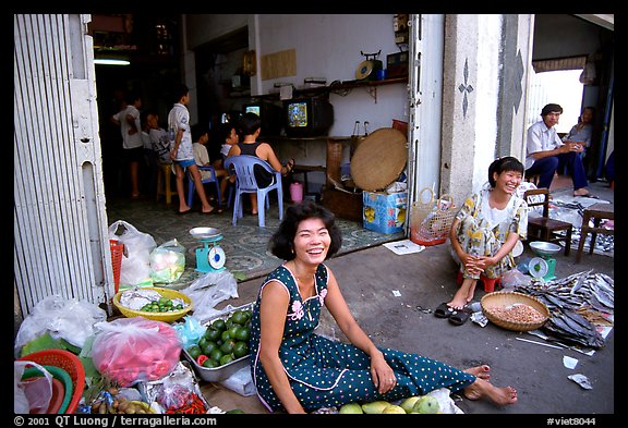 Old and new: street vendors and kids playing in a video games store. Ho Chi Minh City, Vietnam (color)