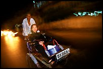 Enjoying the freshness of the night during a cyclo ride. Ho Chi Minh City, Vietnam (color)