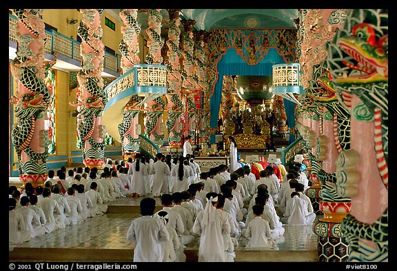 The noon ceremony, attended by priests inside the great Cao Dai temple. Tay Ninh, Vietnam