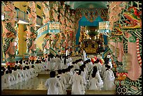 The noon ceremony, attended by priests inside the great Cao Dai temple. Tay Ninh, Vietnam