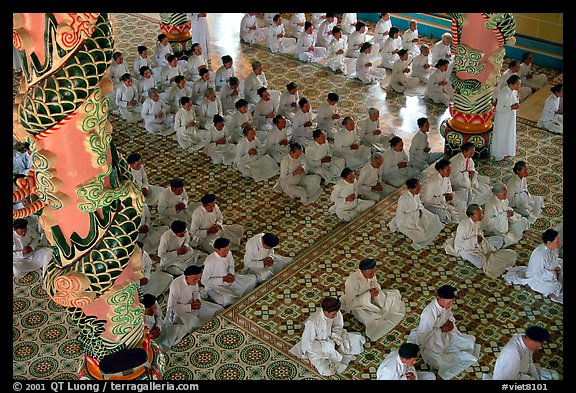 The noon ceremony, attended by priests inside the great Cao Dai temple. Tay Ninh, Vietnam