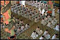 The noon ceremony, attended by priests inside the great Cao Dai temple. Tay Ninh, Vietnam (color)