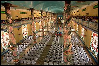 The noon ceremony, attended by priests inside the great Cao Dai temple. Tay Ninh, Vietnam